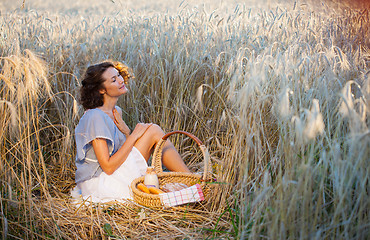 Image showing middle aged beautiful smiling woman with basket outdoors