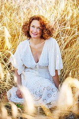 Image showing middle aged pretty smiling woman outdoors