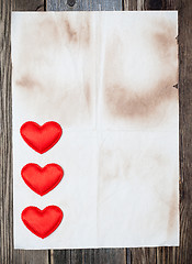 Image showing blank old paper with three red hearts