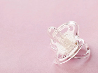 Image showing transparent pacifier on pink background