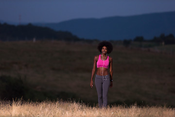 Image showing Young African american woman jogging in nature