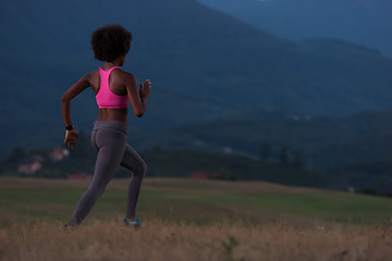 Image showing Young African american woman jogging in nature