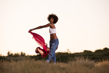 Image showing black girl dances outdoors in a meadow