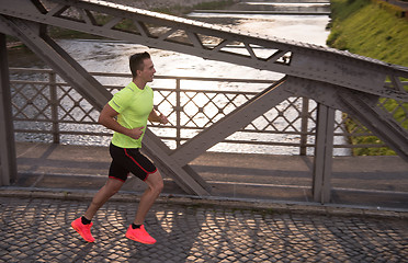 Image showing a young man jogging in the city