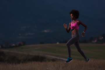 Image showing Young African american woman jogging in nature