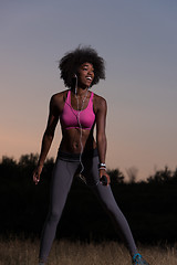 Image showing black woman is doing stretching exercise relaxing and warm up