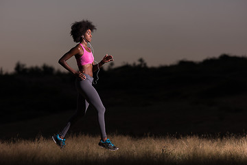 Image showing Young African american woman jogging in nature