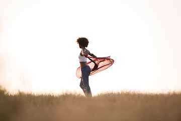 Image showing black girl dances outdoors in a meadow