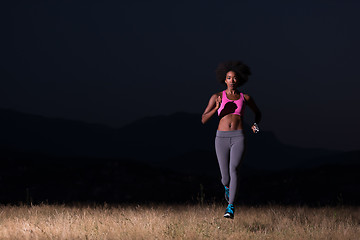 Image showing Young African american woman jogging in nature