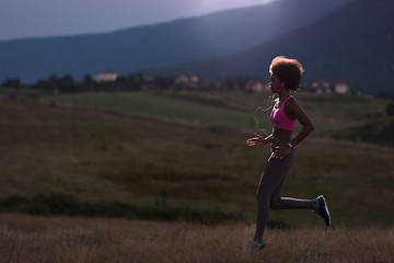 Image showing Young African american woman jogging in nature