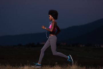 Image showing Young African american woman jogging in nature