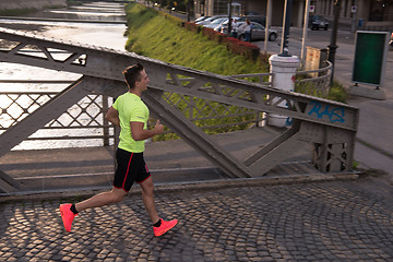 Image showing a young man jogging in the city