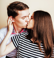 Image showing couple of happy smiling teenagers students, warm colors having a kiss, lifestyle people concept