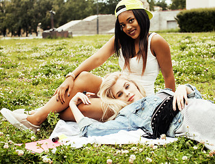 Image showing two pretty girls on grass happy smiling, best friends having fun together, lifestyle people concept