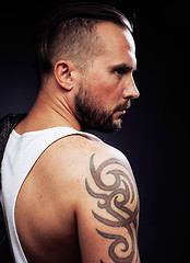 Image showing A man with tattooes on his arms. Silhouette of muscular body. caucasian brutal hipster guy with modern haircut, looking like criminal