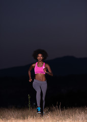 Image showing Young African american woman jogging in nature