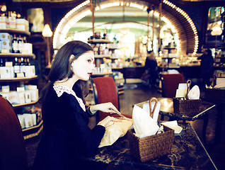 Image showing young elegant brunette woman in cafe drinking coffee, luxury int