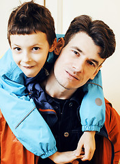 Image showing young handsome father with his son fooling around at home, lifes
