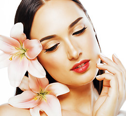 Image showing young attractive lady close up with hands on face isolated flower lily tender concept