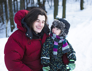 Image showing young happy father with his son little cute boy outside in winter park, lifestyle people concept