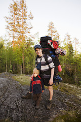 Image showing young happy father traveling with little son and huge backpack, lifestyle people concept