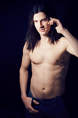 Image showing handsome young man with long hair naked torso on black backgroun