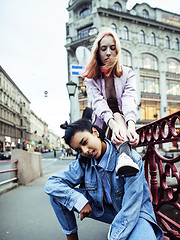 Image showing cute young couple of teenagers girlfriends having fun, traveling europe, modern fashion citylife, lifestyle people concept