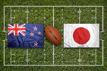 Image showing New Zealand vs. Japan flags on rugby field