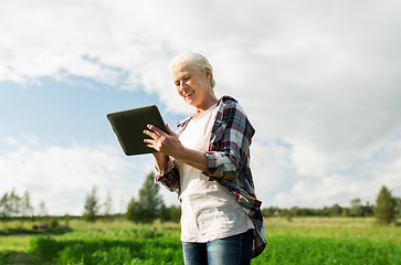 Image showing senior woman with tablet pc computer at county