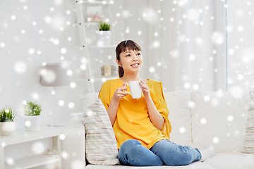 Image showing happy asian woman drinking from tea cup