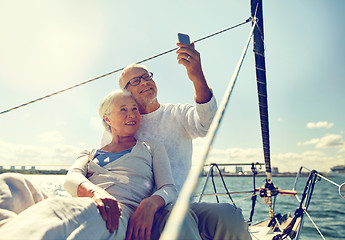 Image showing senior couple taking selfie by smartphone on yacht