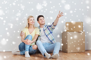 Image showing couple with boxes moving to new home and dreaming