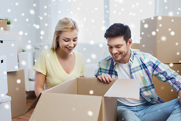 Image showing smiling couple with big boxes moving to new home