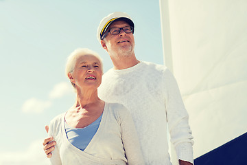 Image showing senior couple hugging on sail boat or yacht in sea