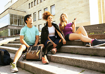 Image showing cute group of teenages at the building of university with books 