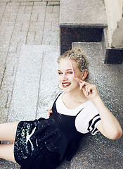 Image showing young pretty party girl smiling covered with glitter tinsel, fas