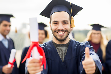 Image showing bachelor showing diploma and thumbs up