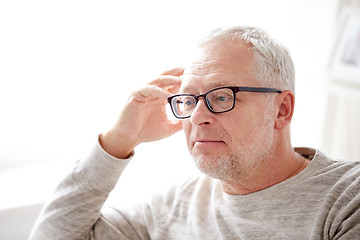 Image showing close up of senior man in glasses thinking