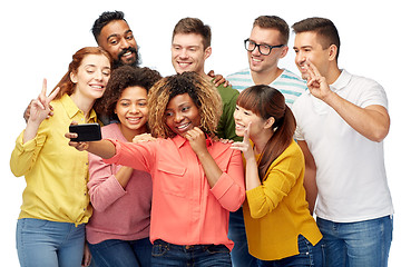 Image showing group of people taking selfie by smartphone