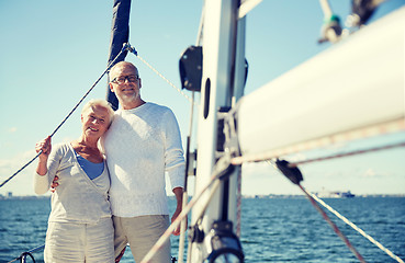 Image showing senior couple hugging on sail boat or yacht in sea