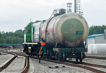 Image showing Shunting locomotive transports tank on other way