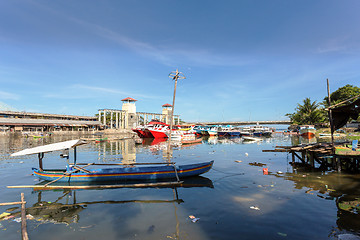 Image showing poor houses by the river in shantytown