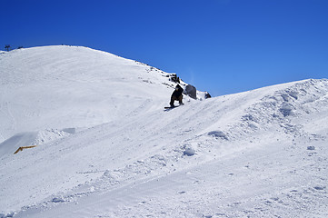 Image showing Snowboarder in snow park at ski resort on sunny winter day