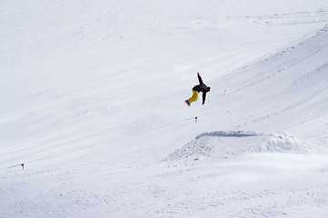 Image showing Snowboarder jumping in snow park at ski resort on sun winter day