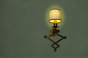 Image showing Old wall lamp made of metal with shade from canvas