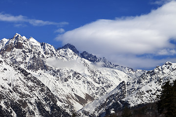 Image showing Snow winter mountains and blue sky with clouds at sun day