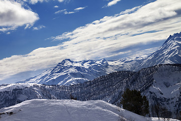 Image showing Off-piste slope and snow winter mountains in sun evening