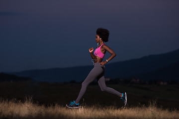 Image showing Young African american woman jogging in nature