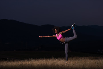 Image showing black woman doing yoga  in the nature