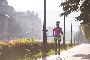 Image showing african american woman jogging in the city